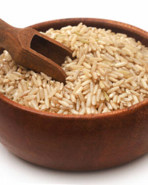 uncooked brown rice in a bowl over white
